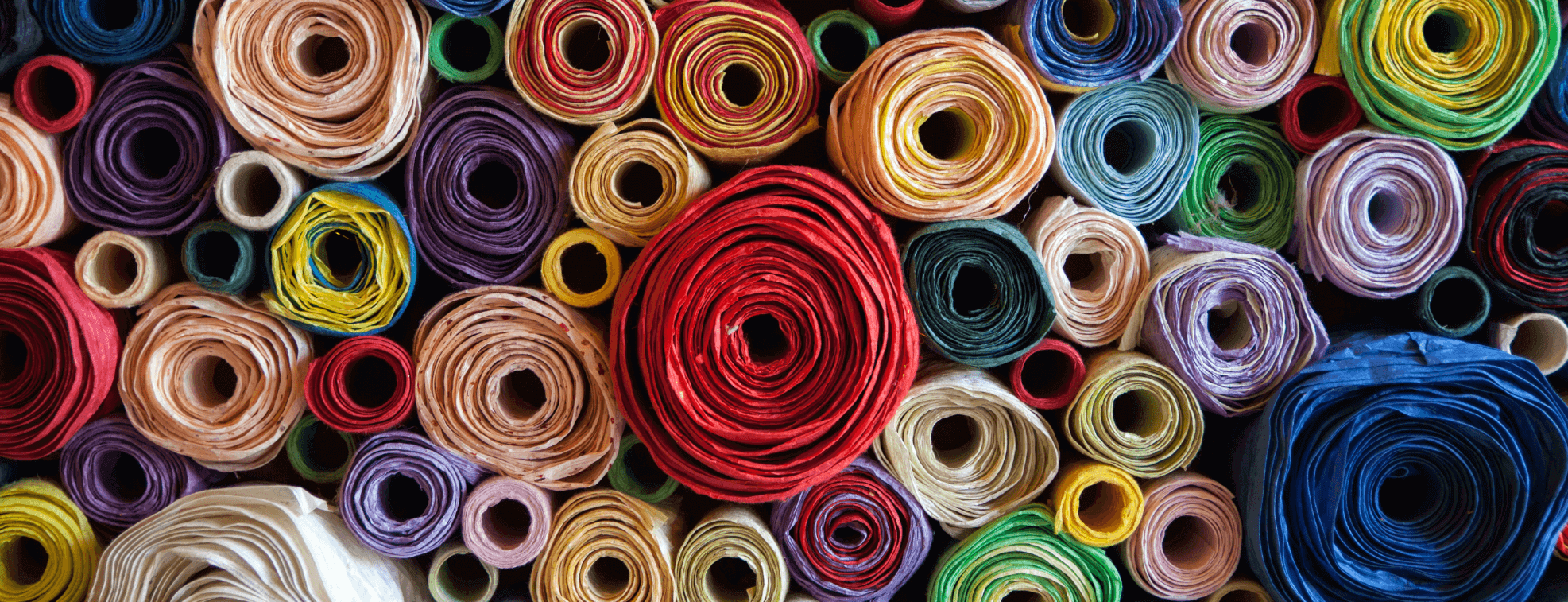 Rolls of different fabric types placed on each other